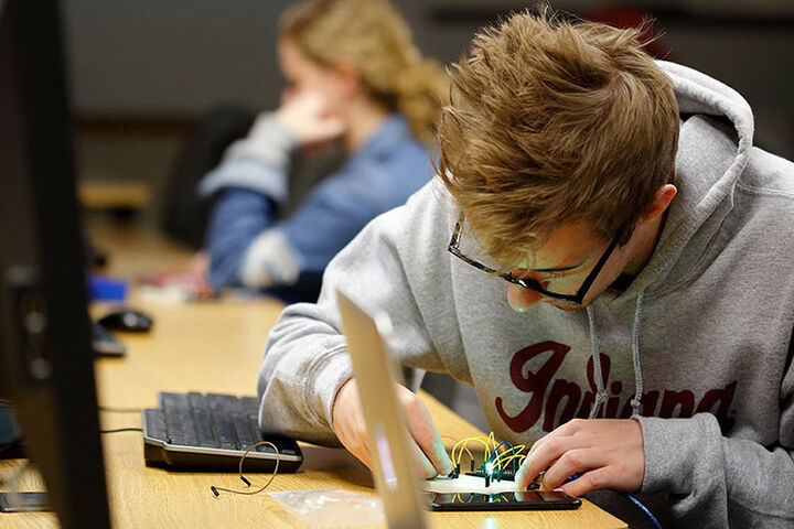 Computer and Information Science Student works on technology.